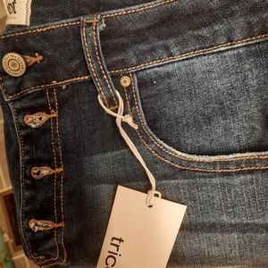 Tricot medium wash button fly skinny jeans